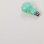 A green lightbulb symbolizing tips